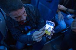 A Syrian refugee shows his home town of Hama on his phone while enroute to Canada.